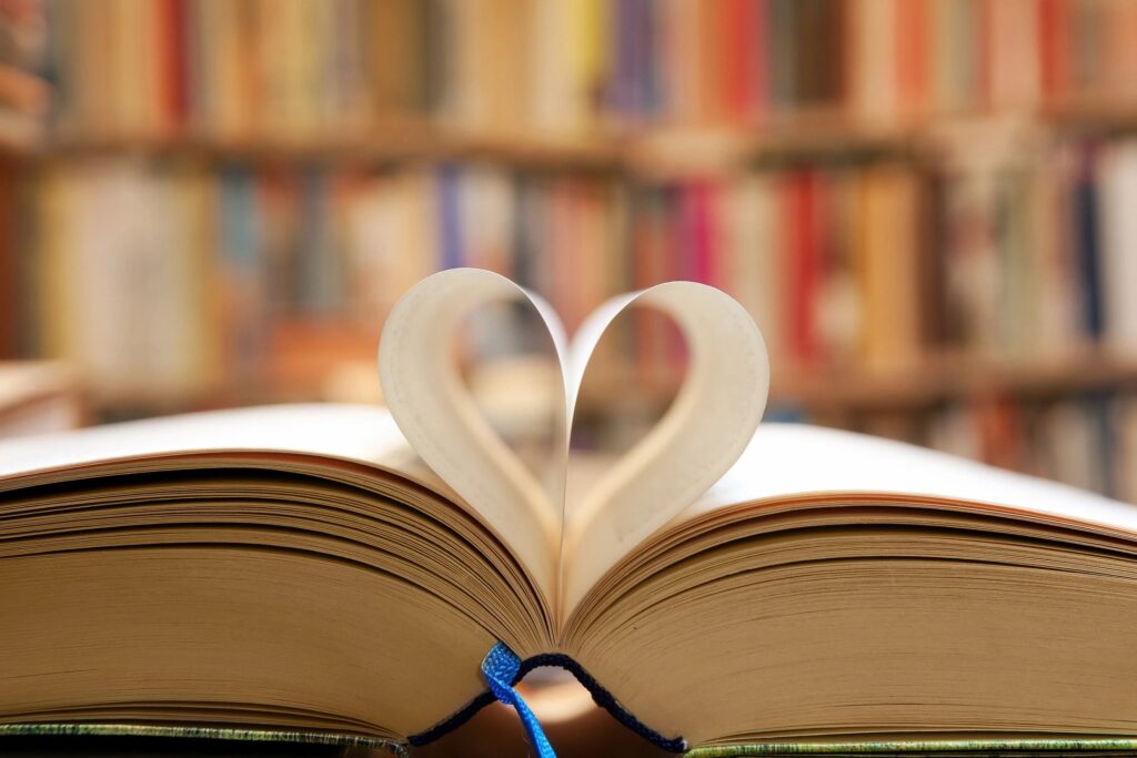 Book with pages in a heart, with bookshelves in the background, for quiz page